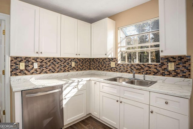 kitchen with white cabinetry, dishwasher, sink, and light stone counters