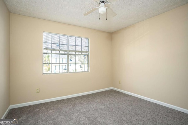 spare room with ceiling fan and carpet