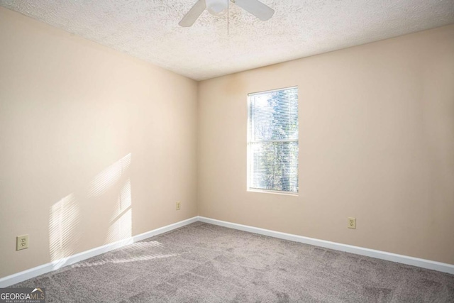 unfurnished room with ceiling fan, carpet, and a textured ceiling