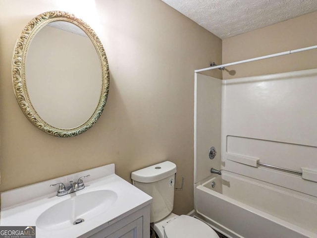 full bathroom with vanity, tub / shower combination, toilet, and a textured ceiling