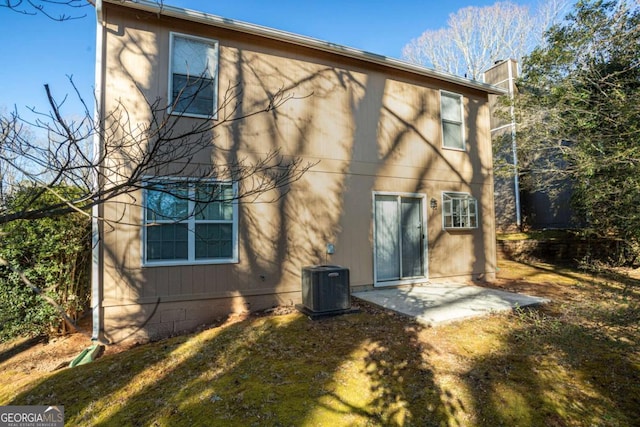 rear view of house with a patio, a yard, and cooling unit