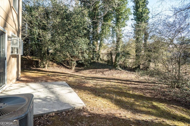 view of yard featuring a patio and central AC