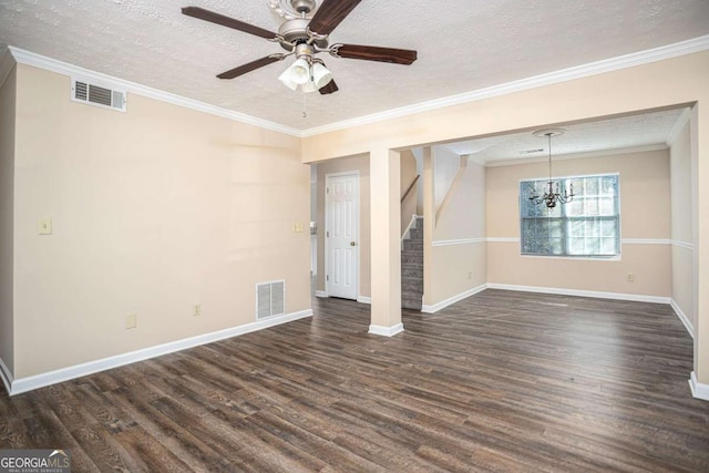 empty room with ornamental molding, dark hardwood / wood-style floors, ceiling fan with notable chandelier, and a textured ceiling