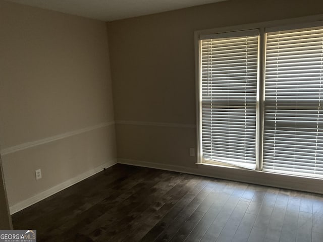 empty room featuring dark hardwood / wood-style flooring