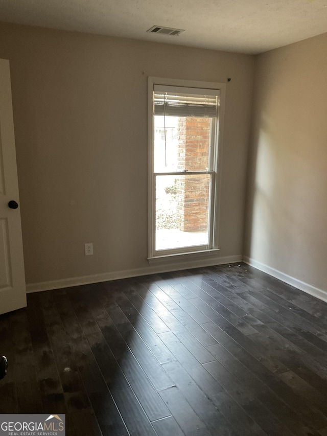 empty room with dark hardwood / wood-style floors