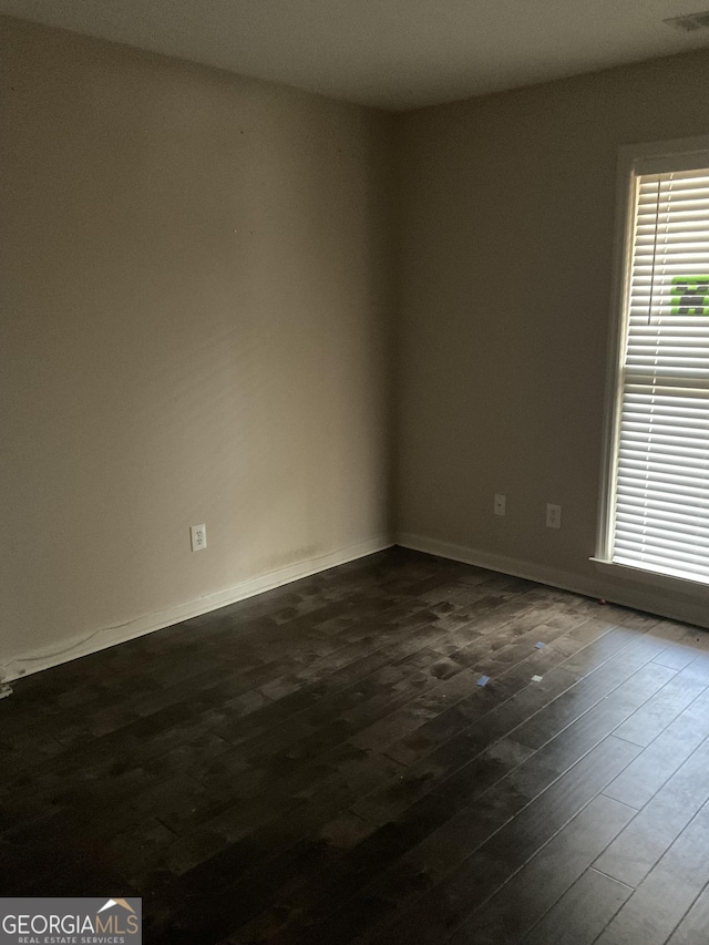 empty room with dark hardwood / wood-style floors