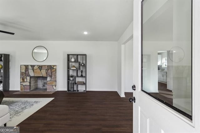 living room with a fireplace and dark hardwood / wood-style flooring