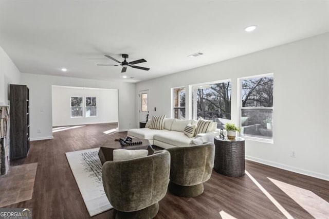 living room featuring dark hardwood / wood-style flooring and ceiling fan