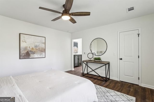 bedroom with dark hardwood / wood-style flooring and ceiling fan