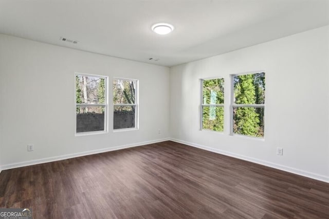 unfurnished room featuring dark hardwood / wood-style flooring