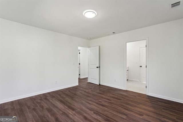 unfurnished room featuring dark hardwood / wood-style flooring