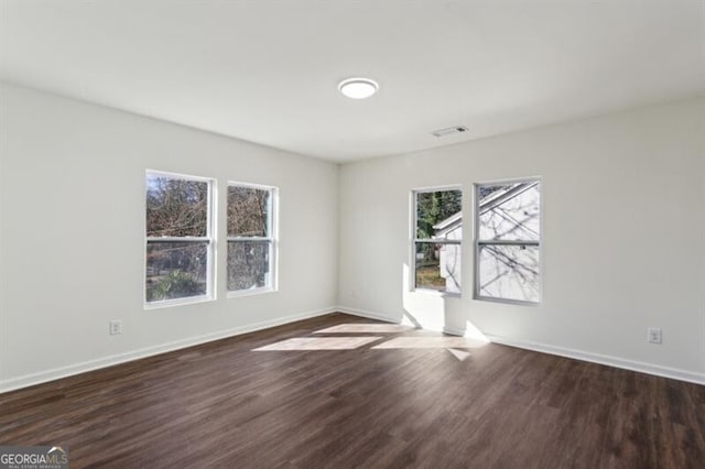 empty room with dark wood-type flooring