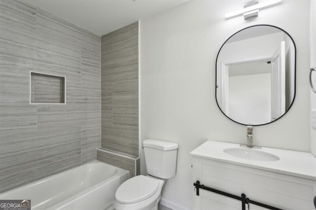 full bathroom featuring vanity, tiled shower / bath, and toilet