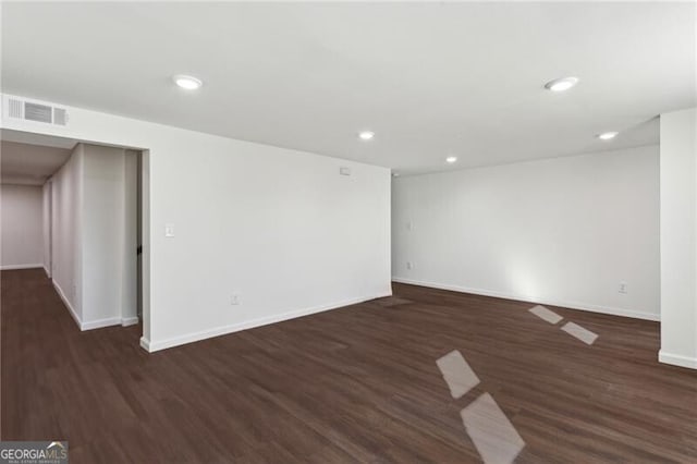 spare room with dark hardwood / wood-style floors