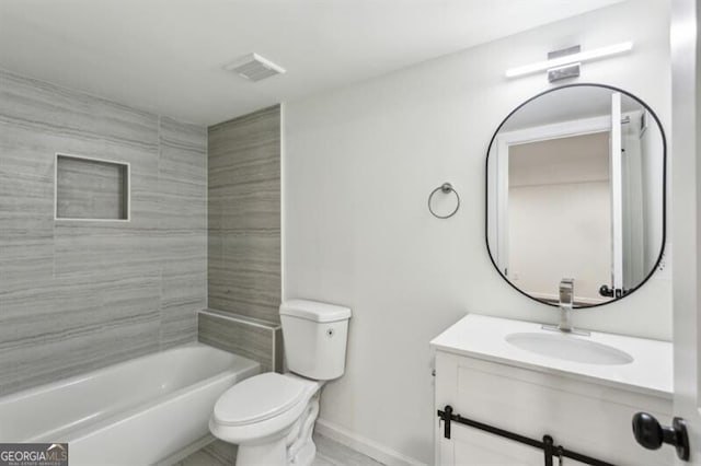 full bathroom featuring tiled shower / bath combo, vanity, and toilet