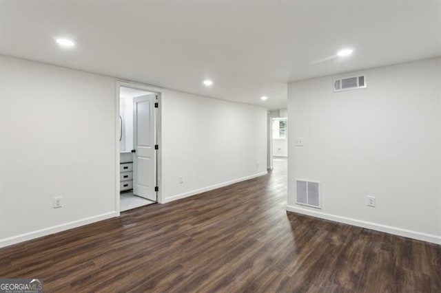 spare room featuring dark wood-type flooring