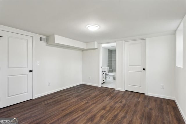 basement featuring dark hardwood / wood-style flooring