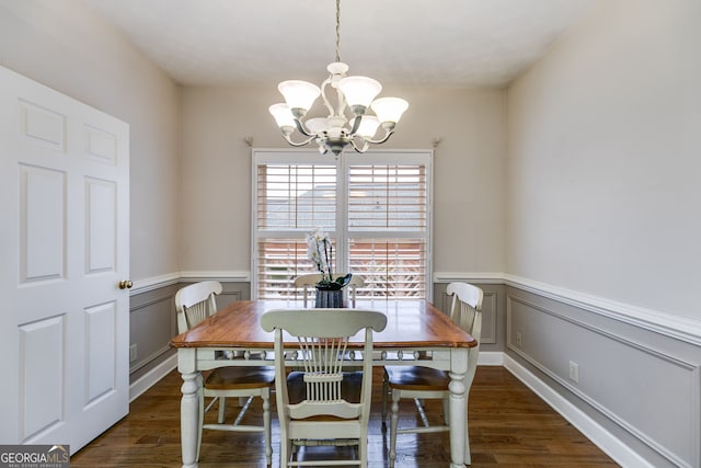 dining room featuring a notable chandelier and dark hardwood / wood-style flooring