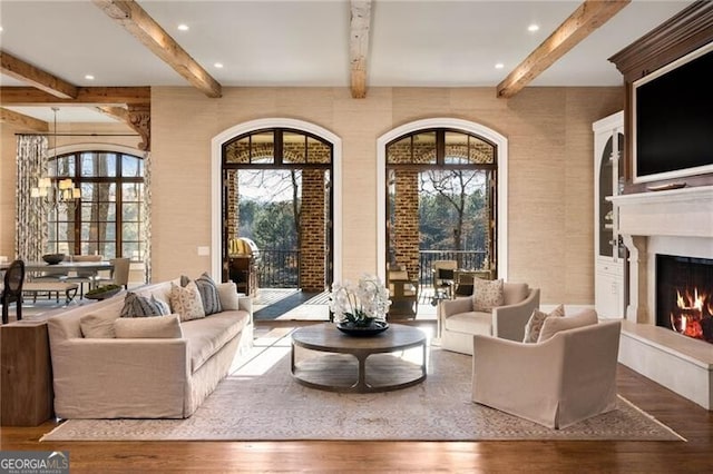 living room with beam ceiling and wood-type flooring