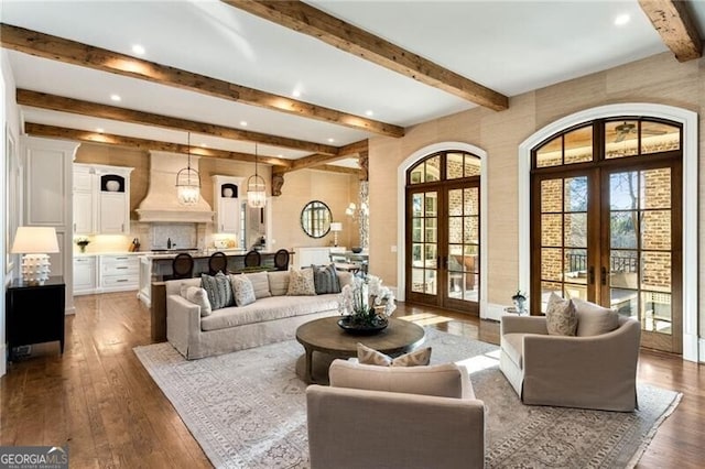 living room with dark hardwood / wood-style floors and french doors