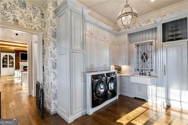 washroom featuring cabinets, separate washer and dryer, sink, and dark hardwood / wood-style floors