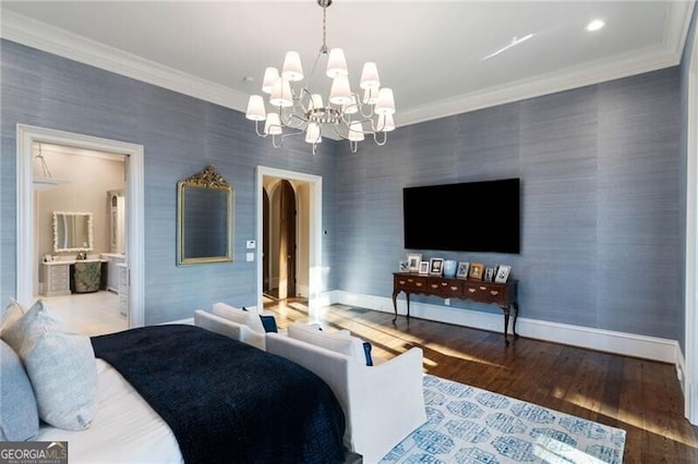 bedroom featuring crown molding, wood-type flooring, connected bathroom, and a chandelier