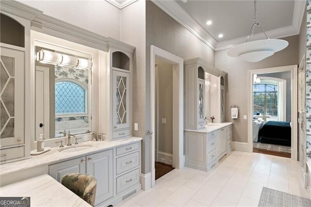 bathroom featuring ornamental molding, a bath, tile patterned flooring, and vanity