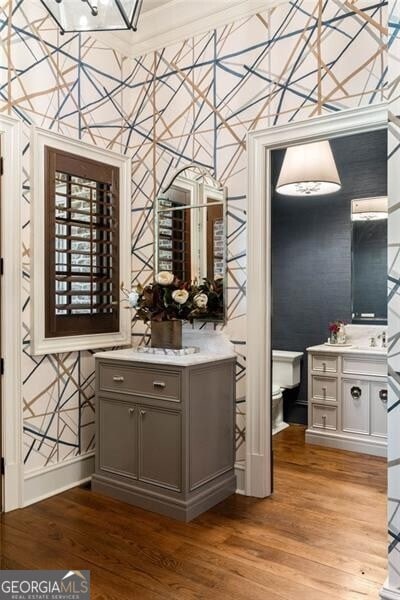 bar with gray cabinets and wood-type flooring