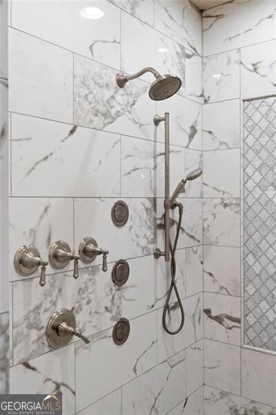 bathroom with a tile shower