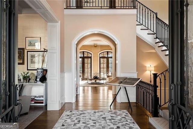 entryway featuring dark wood-type flooring and french doors