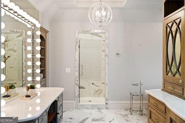 bathroom with vanity, an enclosed shower, and an inviting chandelier