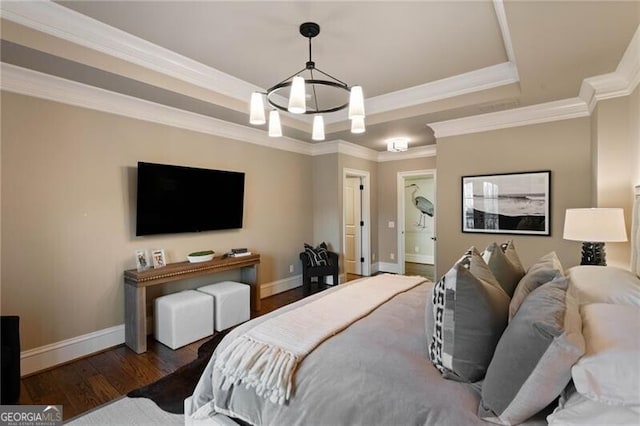 bedroom with crown molding, dark hardwood / wood-style floors, and a tray ceiling