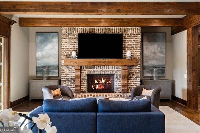 living room featuring beamed ceiling, a brick fireplace, and dark wood-type flooring