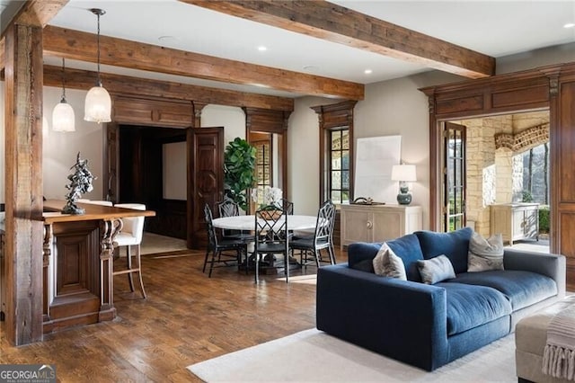 living room with beam ceiling and hardwood / wood-style flooring