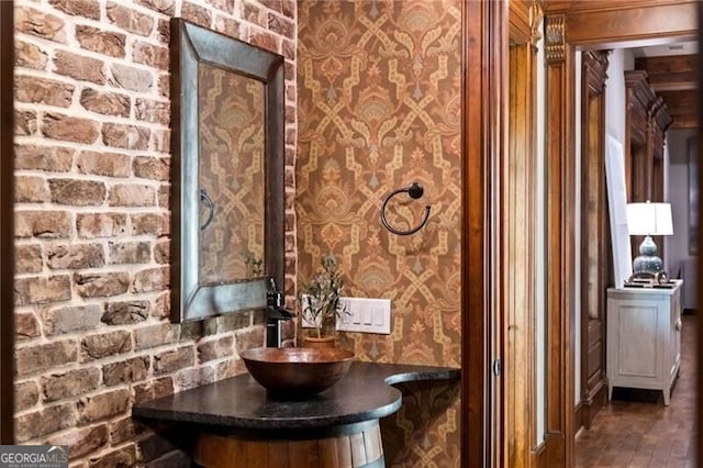 bathroom featuring brick wall