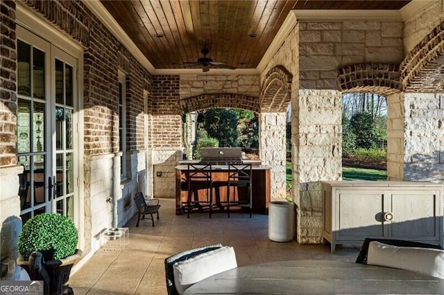 view of patio / terrace with an outdoor kitchen, ceiling fan, and french doors