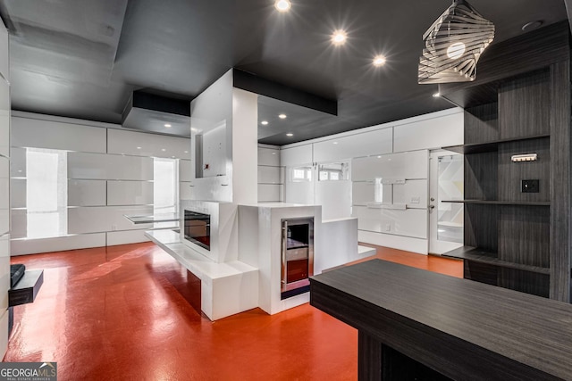 kitchen with hanging light fixtures and white cabinets