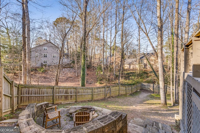 view of yard featuring an outdoor fire pit