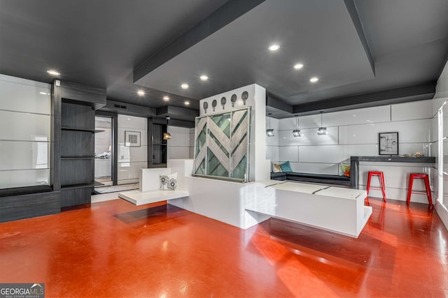 kitchen featuring white cabinetry, hanging light fixtures, and a breakfast bar area