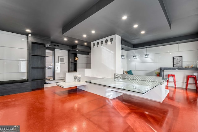 kitchen featuring pendant lighting and concrete floors