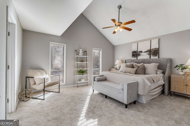 carpeted bedroom featuring high vaulted ceiling and ceiling fan