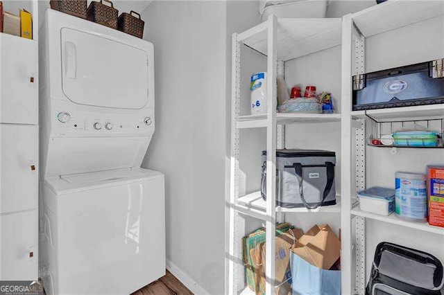 laundry area featuring stacked washer / drying machine