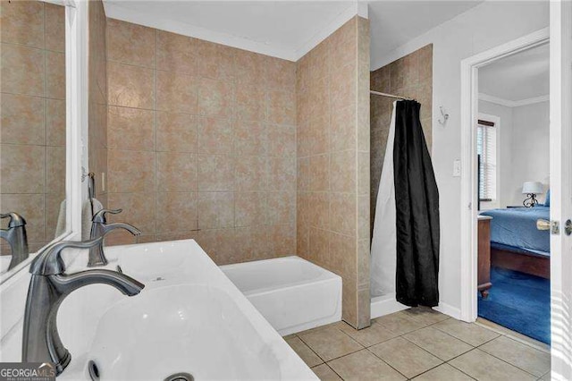 bathroom with curtained shower, ornamental molding, dual sinks, and tile patterned flooring