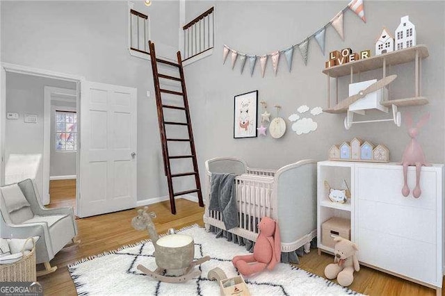 bedroom featuring a crib and hardwood / wood-style floors