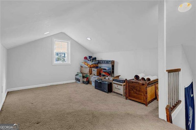 additional living space featuring light carpet and vaulted ceiling