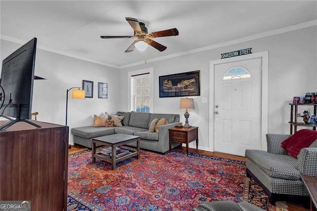 living room with ceiling fan and crown molding