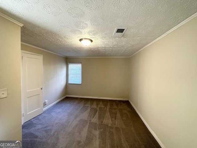 empty room with a textured ceiling, crown molding, and dark colored carpet