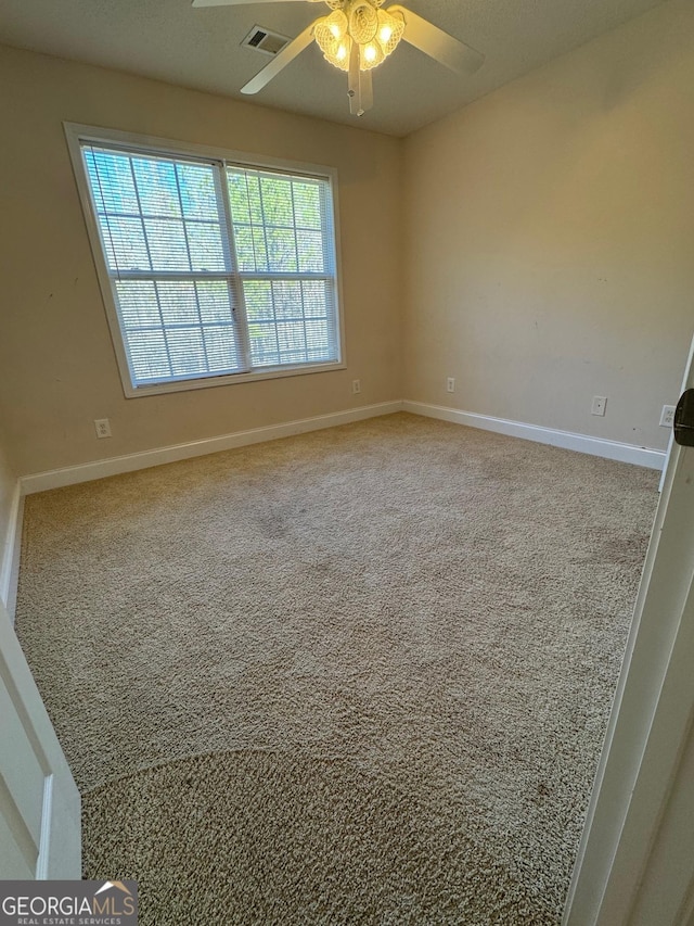 carpeted empty room featuring ceiling fan