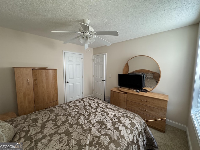 carpeted bedroom with a textured ceiling and ceiling fan