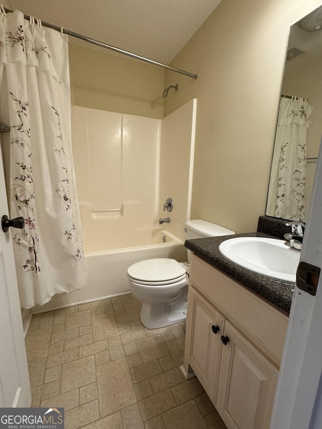 full bathroom featuring toilet, a textured ceiling, shower / bath combination with curtain, and vanity